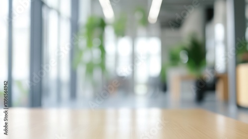 A modern office interior with large windows and greenery visible during daylight showcasing a workspace ambiance