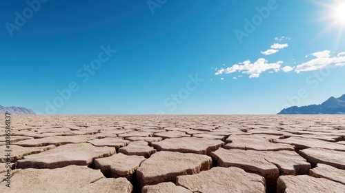 A vast, cracked desert landscape under a clear blue sky.