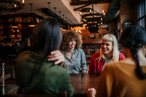 Friends having a good time, chatting in a restaurant photo