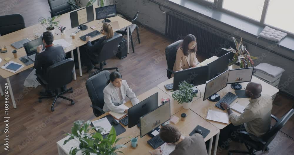 Top view of people office employees working at desks in modern open space workplace. Career development and coworking center concept.