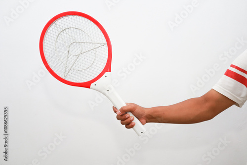 red and white mosquito racket held by asian man photo