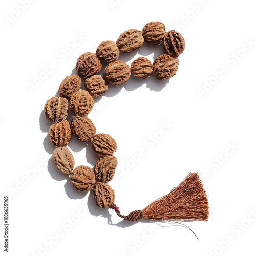 Strung peach pits on a white background