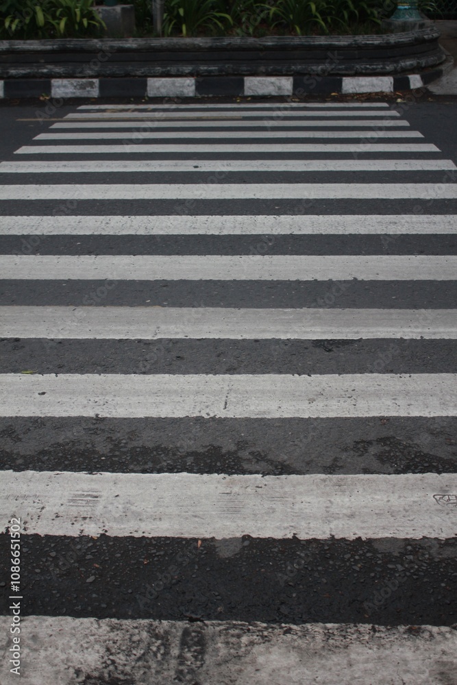 Close-Up View of a Pedestrian Crosswalk with Black and White Striped Zebra Lines on Asphalt Road Surface, Urban Street Safety Design for Traffic Management and Pedestrian Crossing Close-Up View of a Pedestrian Crosswalk with Black and White Striped Zebra Lines on Asphalt Road Surface, Urban Street Safety Design for Traffic Management and Pedestrian Crossing