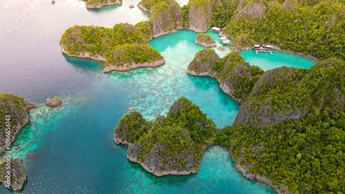 Aerial view of exotic island with turquoise water in Raja Ampat.
