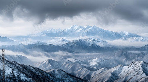  In the early morning, there is fog on top of snow-capped mountains