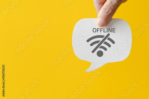 Quadro su tela Hand holding real white speech bubble paper cut with offline text and symbol on