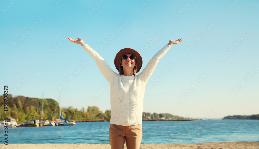 Happy smiling traveler woman on sunny beach, joyful girl enjoying on sea coast background Happy smiling traveler woman on sunny beach, joyful girl enjoying on sea coast background