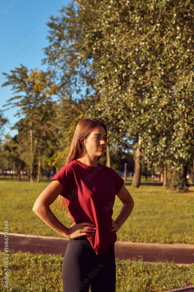 Young woman warming up for exercise and jogging in urban park during sunny summertime day. Young woman warming up for exercise and jogging in urban park during sunny summertime day.