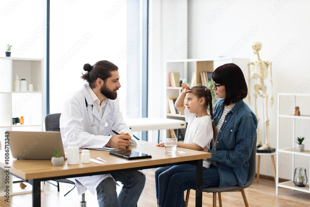 Little girl with mother at doctor examination in modern clinic office. Female child and parent consulting male doctor about health concerns. Pediatrician offers guidance during routine checkup. Little girl with mother at doctor examination in modern clinic office. Female child and parent consulting male doctor about health concerns. Pediatrician offers guidance during routine checkup.