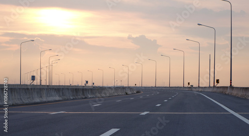 Panoramic city skyline and mountain with empty asphalt road at sunset