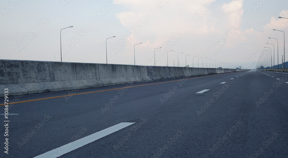 Fototapeta premium Panoramic city skyline and mountain with empty asphalt road at sunset