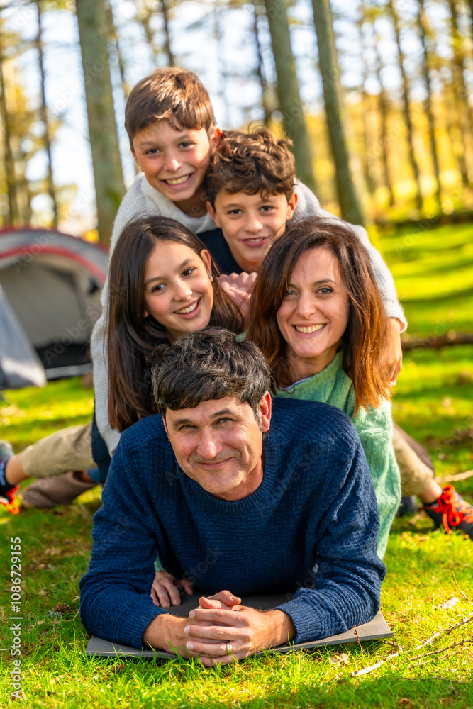 Fototapeta premium Family having fun together lying on the forest