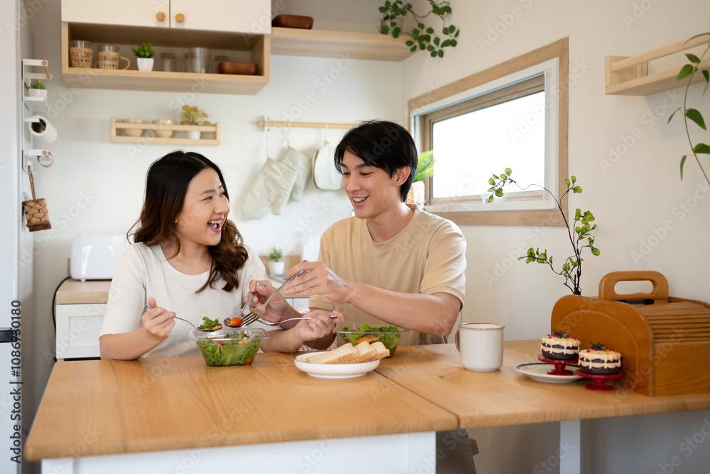 Beautiful adult couple enjoying a healthy meal together at home Beautiful adult couple enjoying a healthy meal together at home