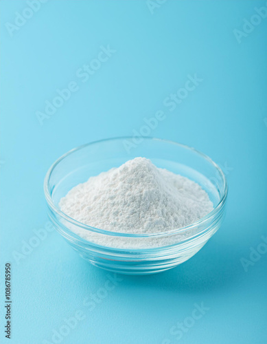 Glass plate of white titanium dioxide powder on blue backdrop. Calcium carbonate, magnesium photo