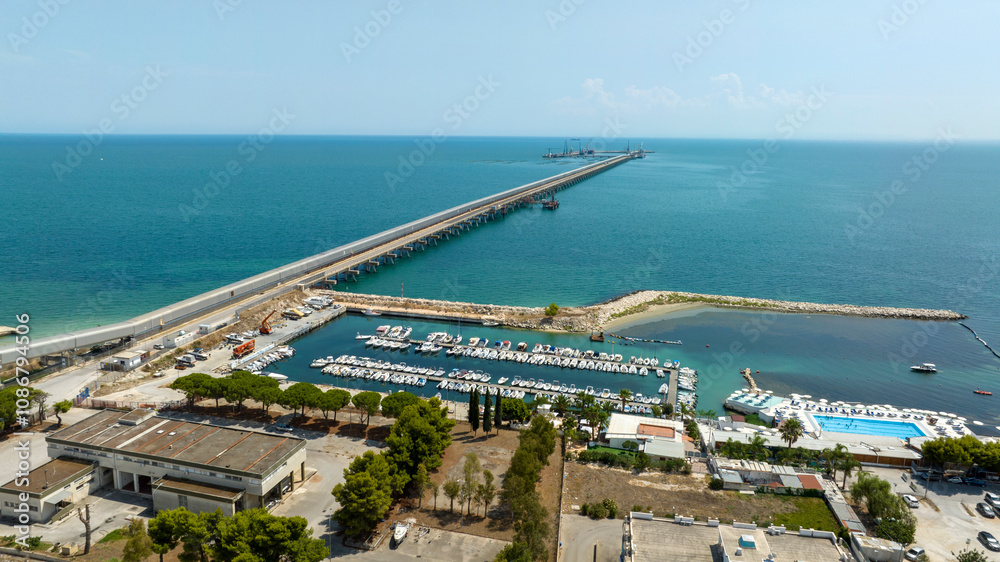 Naklejka premium Aerial view of a long jetty on the Mediterranean Sea.