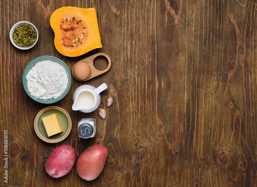 Prepared ingredients for pumpkin gnocchi or dumplings on brown wooden background. Recipes pumpkin.