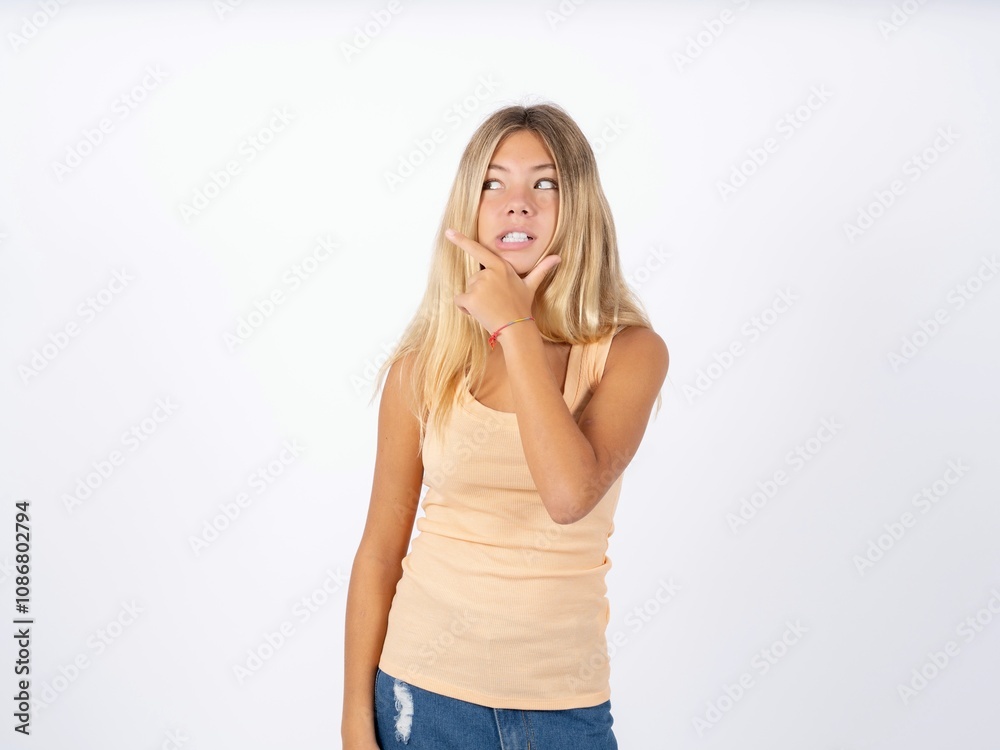 Beautiful teen girl wearing sleeveless t-shirt Thinking worried about a question, concerned and nervous with hand on chin.