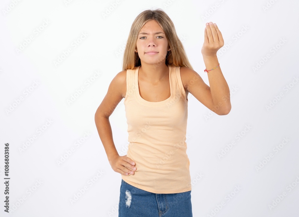 Beautiful teen girl wearing sleeveless t-shirt angry gesturing typical italian gesture with hand, looking to camera Beautiful teen girl wearing sleeveless t-shirt angry gesturing typical italian gesture with hand, looking to camera