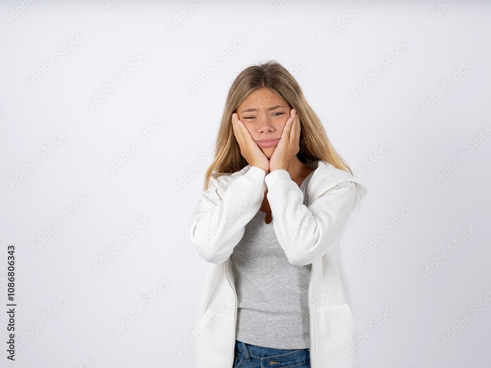 Beautiful teen girl wearing white jacket Tired hands covering face, depression and sadness, upset and irritated for problem Beautiful teen girl wearing white jacket Tired hands covering face, depression and sadness, upset and irritated for problem