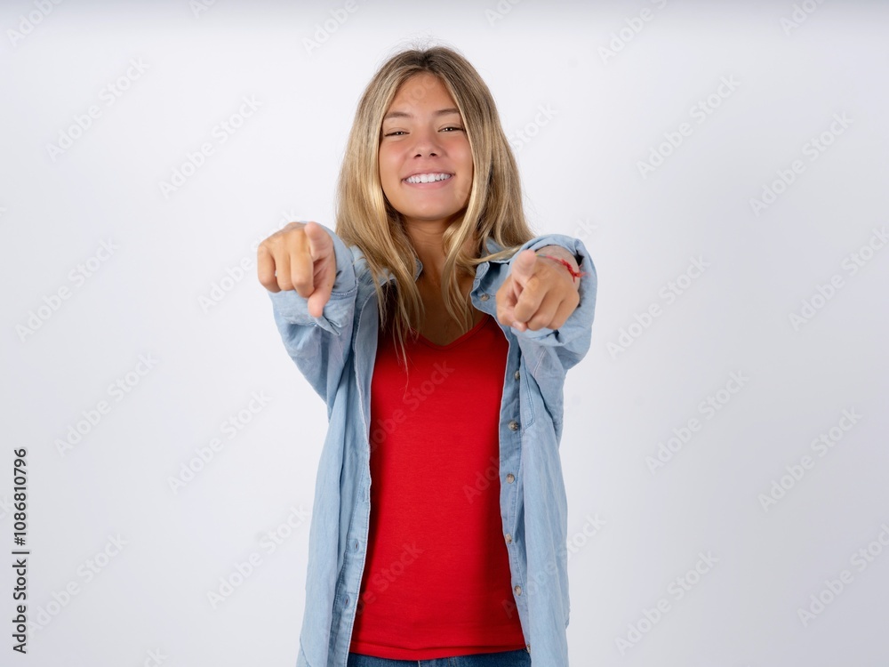 Beautiful teen girl wearing denim jacket cheerful and smiling poiting at camera Beautiful teen girl wearing denim jacket cheerful and smiling poiting at camera