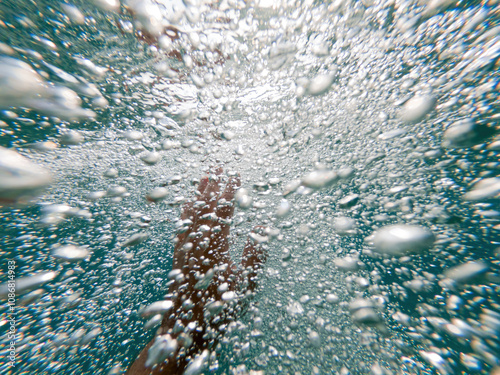 Картината върху платно Drowning man lifting his hand up through deep ocean water to ask for help and as