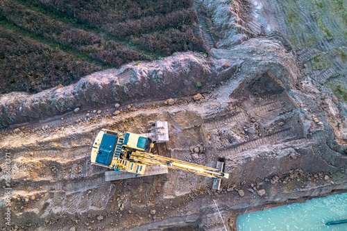 an excavator digging a trench at a construction site, top view from a drone, background for construction concept photo