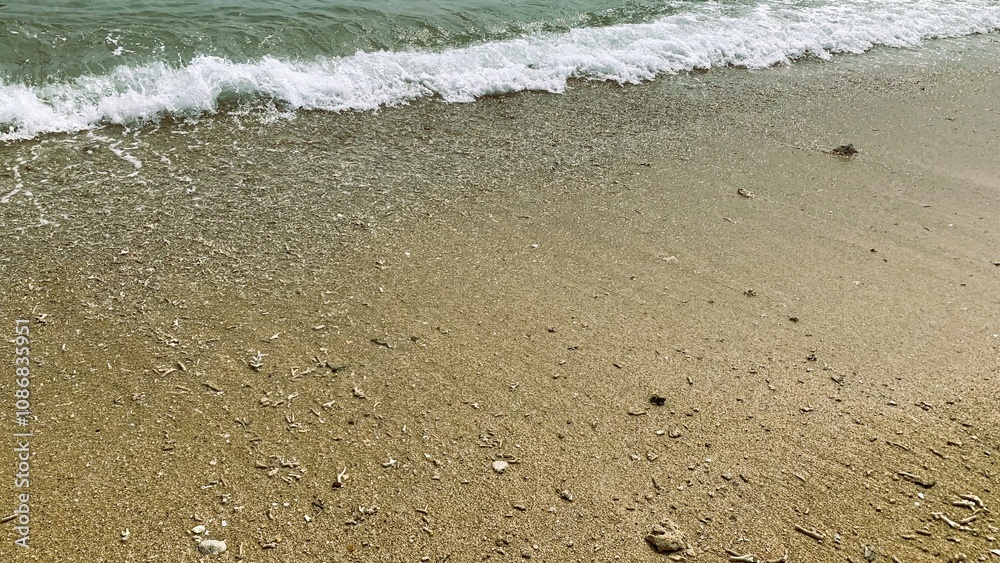 Small waves on a beach, Tiny waves lapped at the shore. Gentle ripples danced across the calm, shallow water. Kondang Merak Beach in Malang Indonesia Small waves on a beach, Tiny waves lapped at the shore. Gentle ripples danced across the calm, shallow water. Kondang Merak Beach in Malang Indonesia