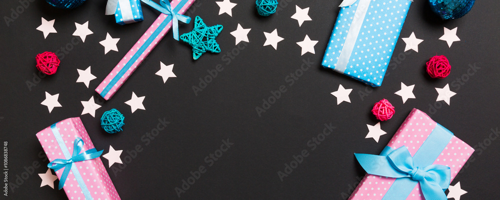 Fototapeta premium Top view of Christmas decorations on black background. New Year holiday concept with copy space