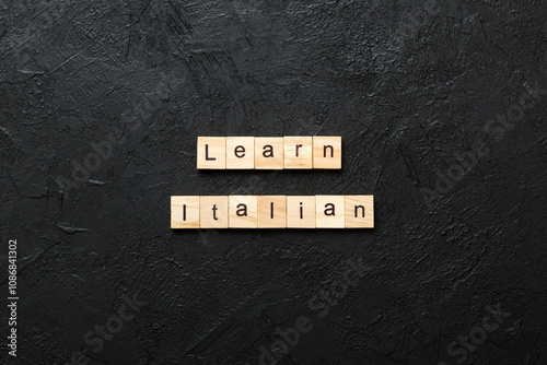 learn italian word written on wood block. learn italian text on table, concept photo