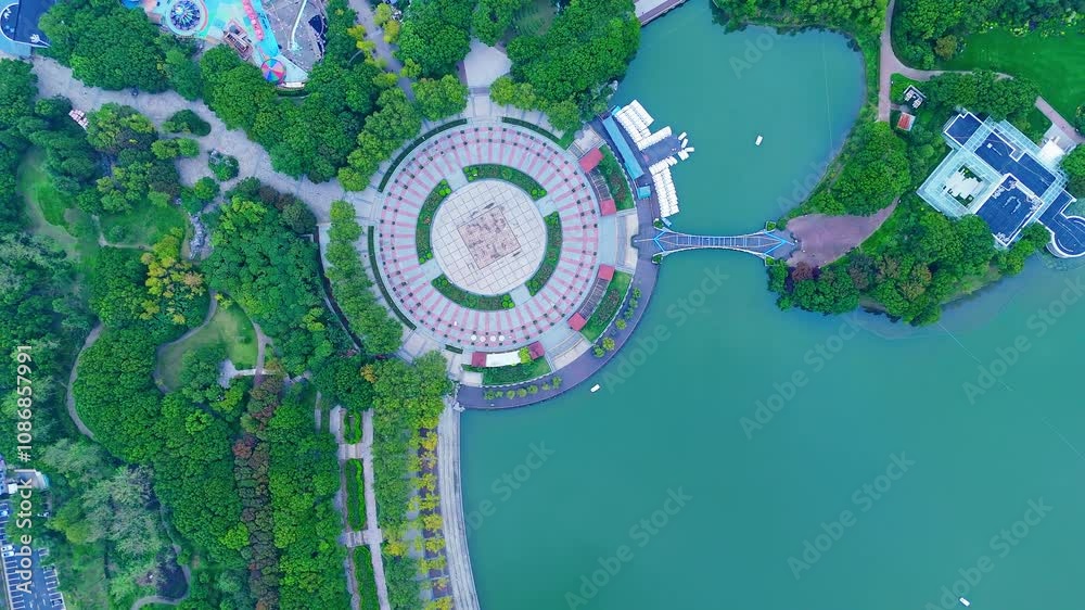 4K real time Aerial view of beautiful forest park and modern city skyline.