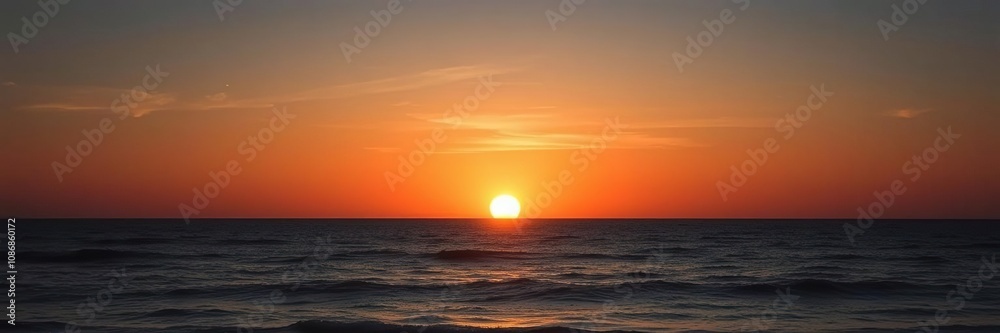 The setting sun casts a golden glow over the ocean as the day succumbs to night, ocean, clouds The setting sun casts a golden glow over the ocean as the day succumbs to night, ocean, clouds