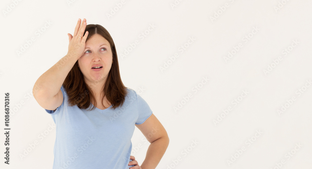 Portrait of unhappy displeased and annoyed young arrogant woman in blue top facepalming with irritation breathing out with opened mouth and rolling eyes from annoyance and exhaust Portrait of unhappy displeased and annoyed young arrogant woman in blue top facepalming with irritation breathing out with opened mouth and rolling eyes from annoyance and exhaust
