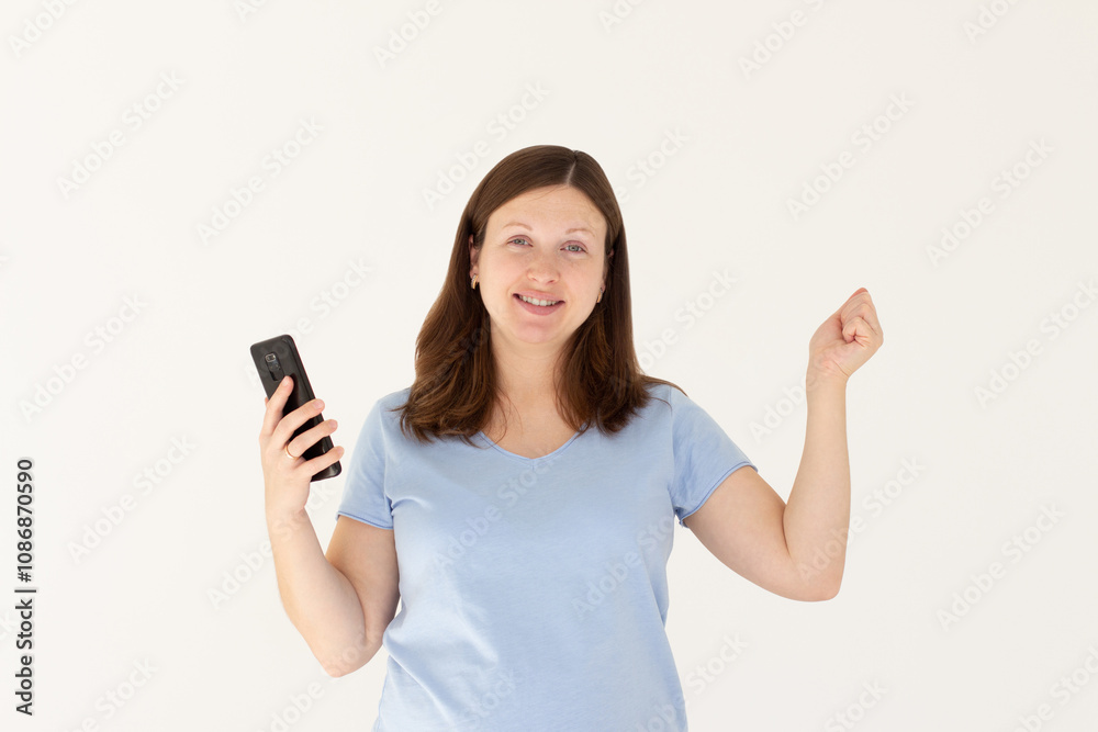 Extremely happy as a winner young woman celebrating victory in bets online casino lottery with money fortune using smart phone cellphone isolated in white background Extremely happy as a winner young woman celebrating victory in bets online casino lottery with money fortune using smart phone cellphone isolated in white background