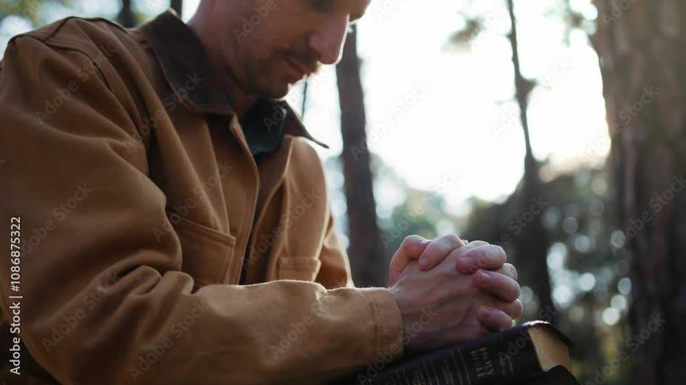 Christian read and pray with holy bible in forest with Holy light shining. Pray to God to confess your sins and ask for blessings to overcome his problems. faith, and religion.