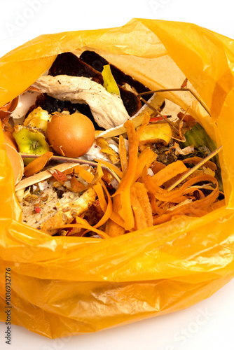 Bio organic trash sorted in yellow plastic bag for composting or recycling isolated on white background. 