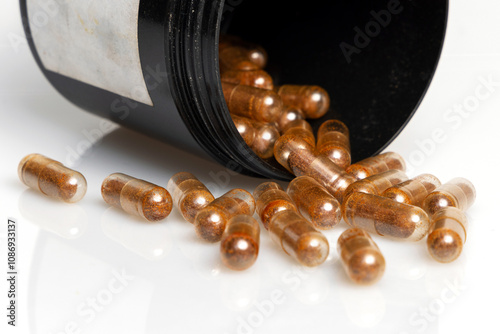 Cordyceps mushroom powder in capsules isolated on white background. Long and healthy life, longevity theme
