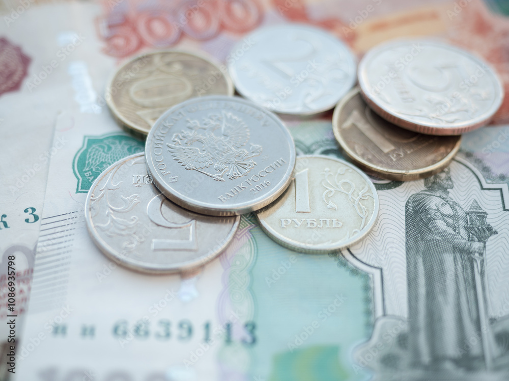 Stack of Russian Banknotes and Coins on a Table Stack of Russian Banknotes and Coins on a Table