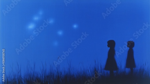 Children gazing at mysterious night sky stars in blue silhouette photo