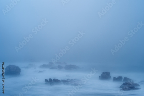 Fototapeta Naklejka Na Ścianę i Meble -  Sea fog (mist) along the West Coast shoreline near Lamberts Bay, Western Cape, South Africa.