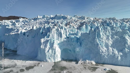 Impressive calving of ice at Eqi Glacier in Greenland during expedition. Eqip Sermia is one of the most frequently calving glaciers.