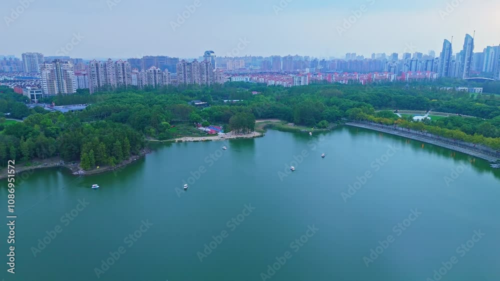 4K real time Aerial view of beautiful forest park and modern city skyline. 4K real time Aerial view of beautiful forest park and modern city skyline.