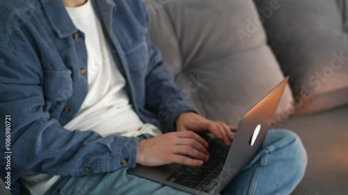 Wallpaper Mural A student with a laptop does homework while sitting on the sofa.
A man studies online.
Online training in college.
Distance learning during a pandemic Torontodigital.ca