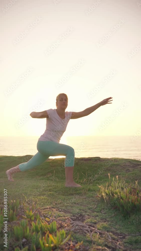 Woman performs a lunging yoga pose on the beach at sunrise, embracing the calm atmosphere and breathtaking ocean view while enhancing her flexibility and strength. Woman performs a lunging yoga pose on the beach at sunrise, embracing the calm atmosphere and breathtaking ocean view while enhancing her flexibility and strength.