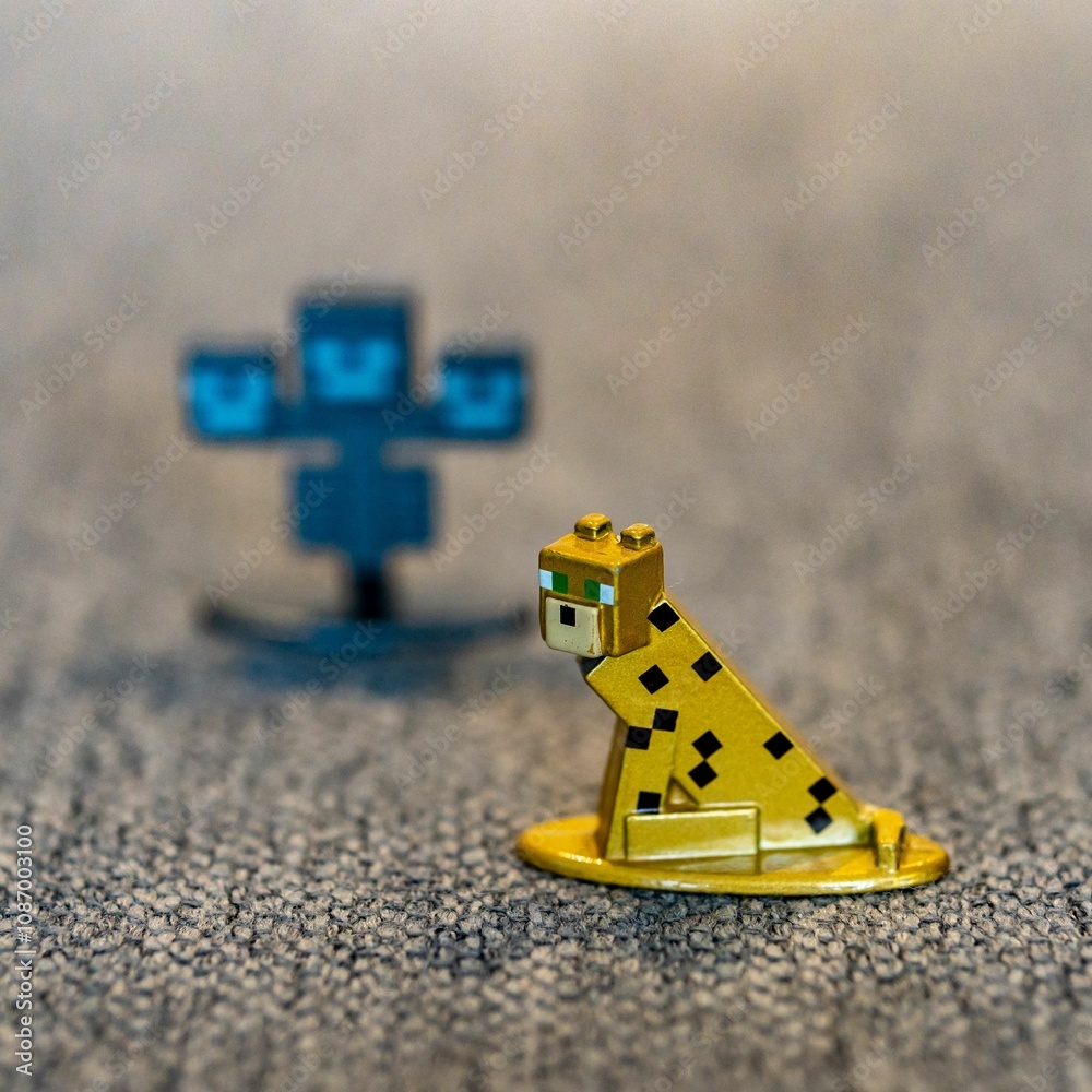 Naklejka premium Closeup shot of a Minecraft ocelot cat toy figurine made of metal.