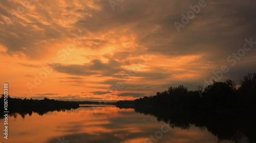 Riverside sunrise timel apse in 4K resolution, People going for fishing in early morning