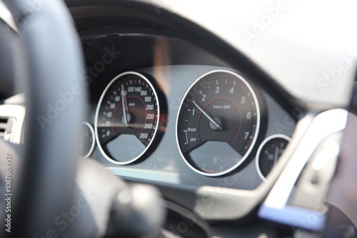 A close up of a car with the speedometer showing the speedometer.