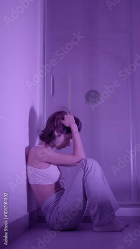 Girl sitting in the bathroom feeling hurt because her boyfriend hasn't called photo