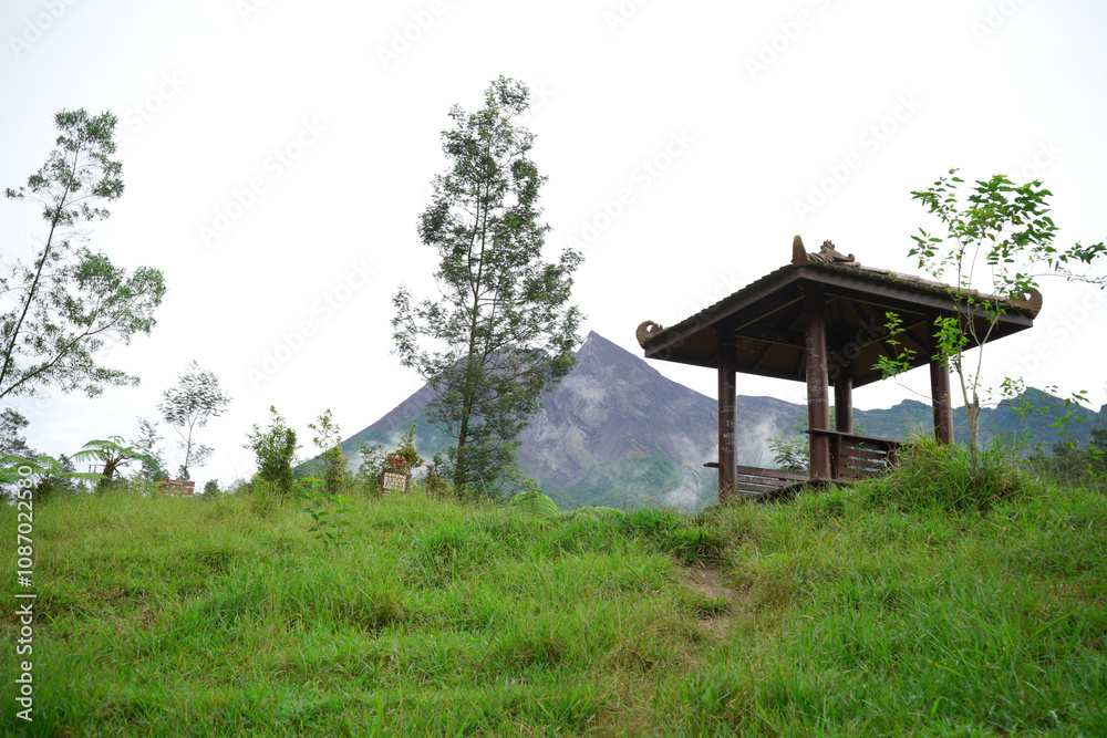 Wooden gazebo with view of Mount Merapi in the morning Wooden gazebo with view of Mount Merapi in the morning