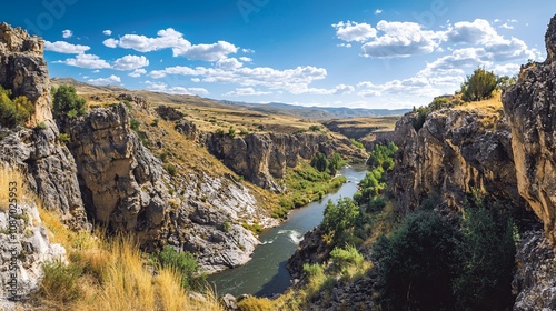 Serene River Landscape Surrounded by Rocky Cliffs and Blue Skies