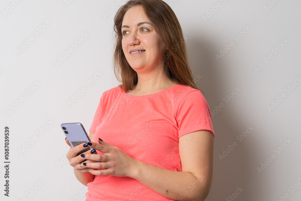 Woman wear braces using smartphone at home Woman wear braces using smartphone at home